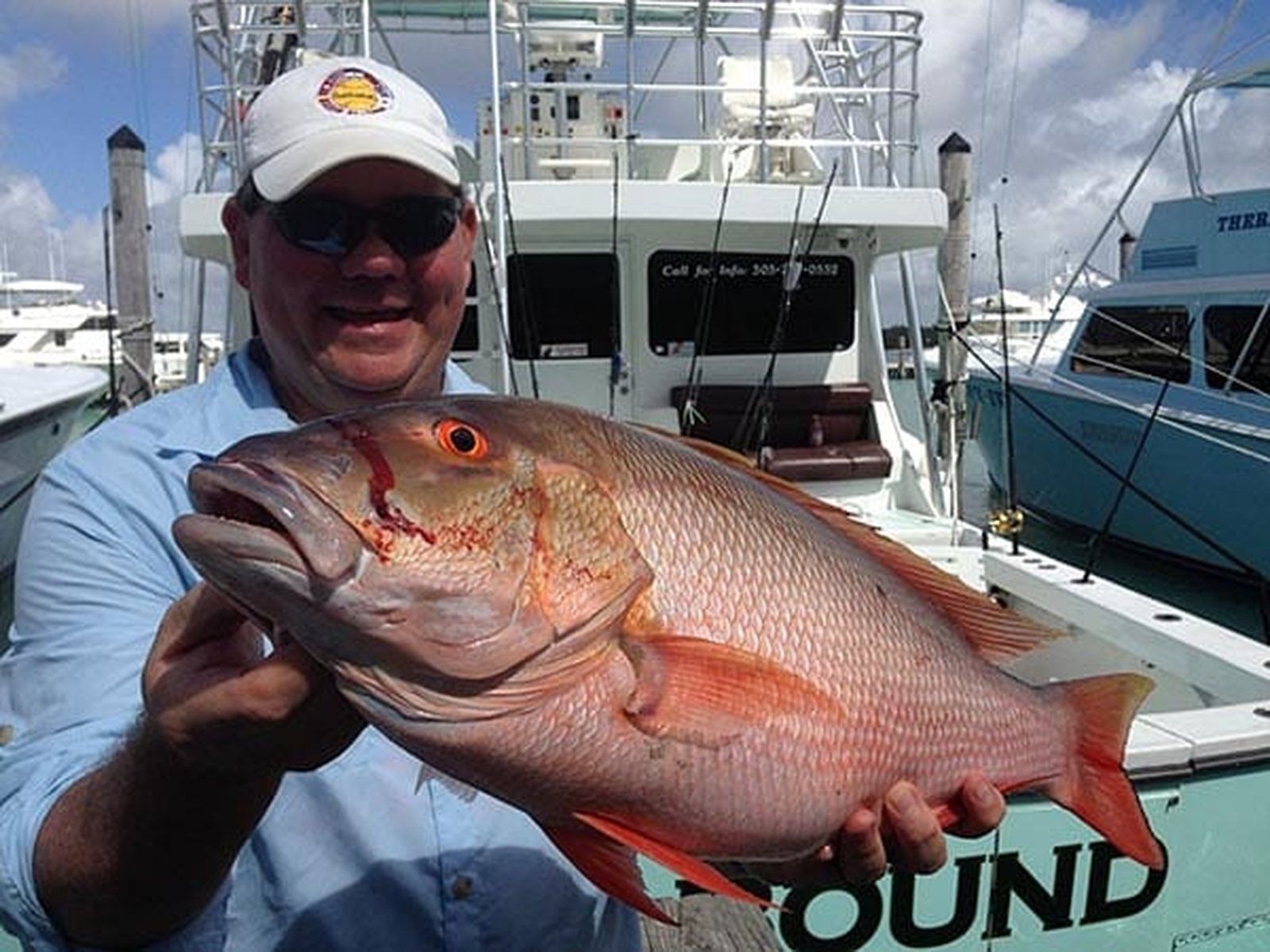 Angler with a mutton snapper caught aboard Spellbound, Miami